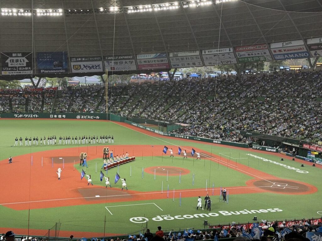 試合前のオープニングセレモニーで和太鼓を叩く人とブルーレジェンズが旗を振っている